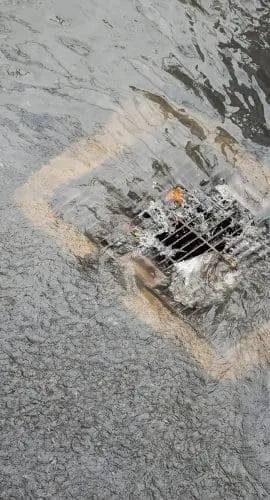 Flood After The Rain Is Flowing Down The Drain On The Road