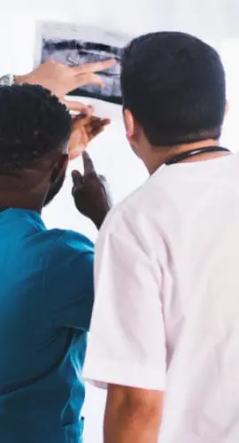 Three person looking at x ray result