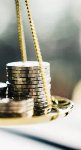 Coins stack with balance scale. Money management, financial plan, time value of money, business idea and Creative ideas for saving money concept.
