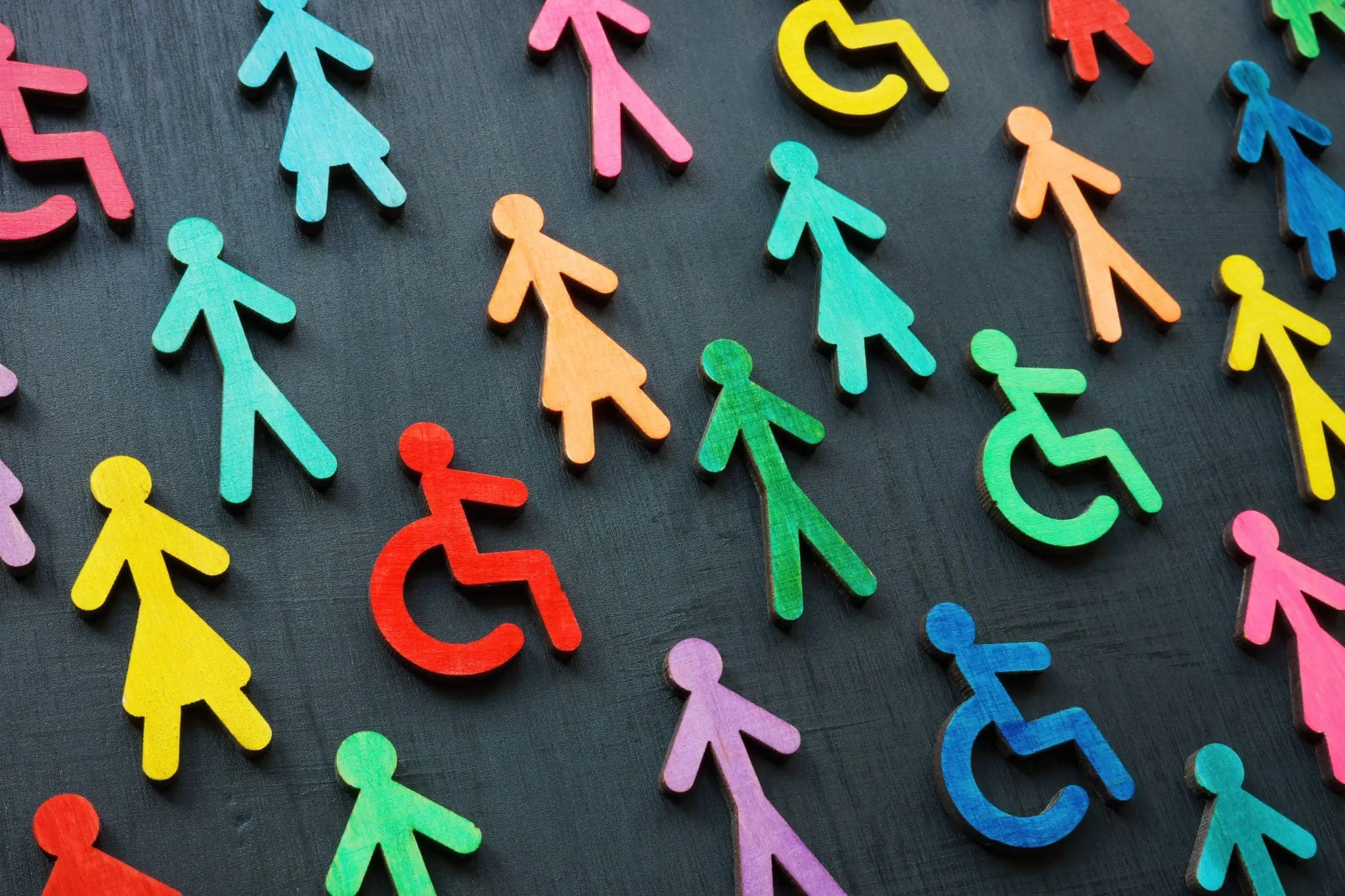 Colorful figurines on the dark surface. Diversity and inclusion concept.