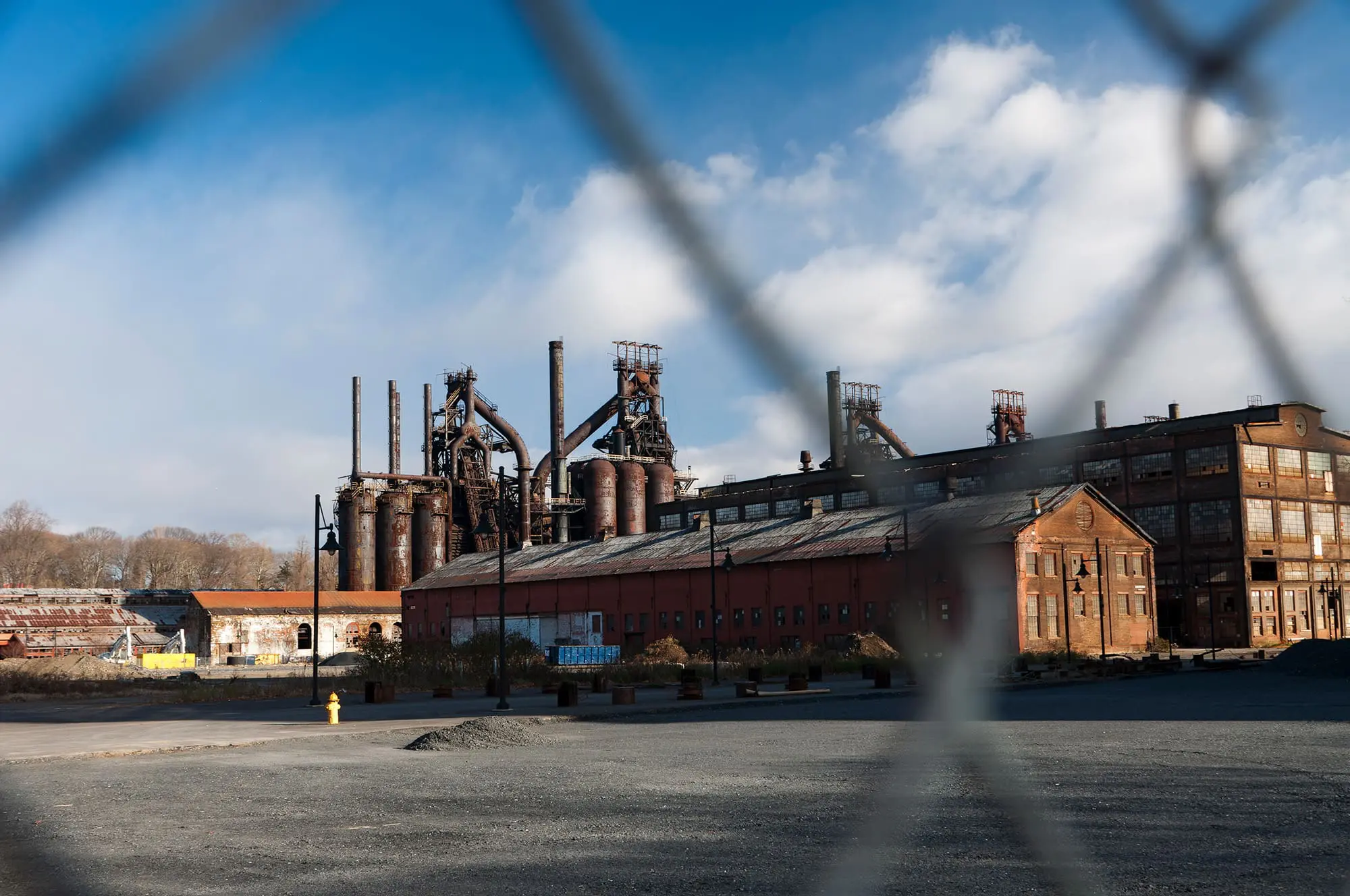 Abandoned Factory Through Fence View